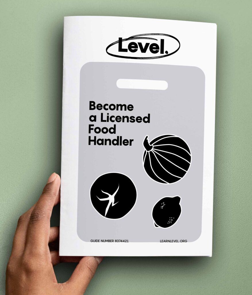 Hand holding a printed version of Level's guide Become A Licensed Food Handler