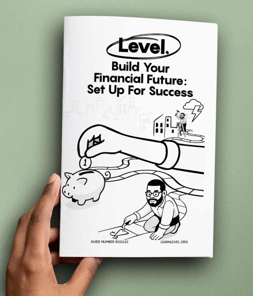 Hand holding a printed version of Level's prison education guide Build Your Financial Future: Set Up For Success