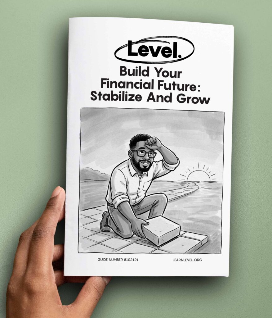 Hand holding a printed version of Level's prison education guide Build Your Financial Future: Stabilize And Grow