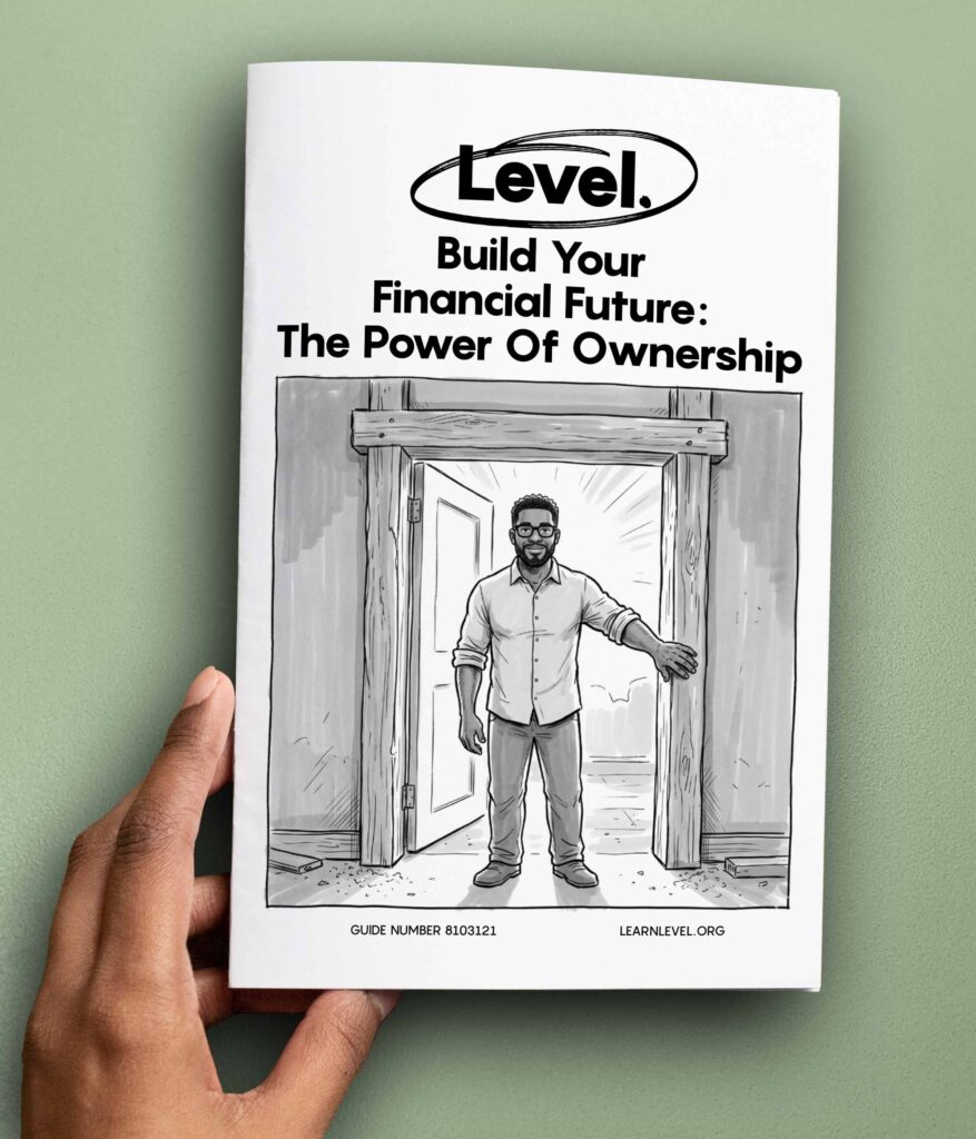 Hand holding a printed version of Level's prison education guide Build Your Financial Future: The Power Of Ownership