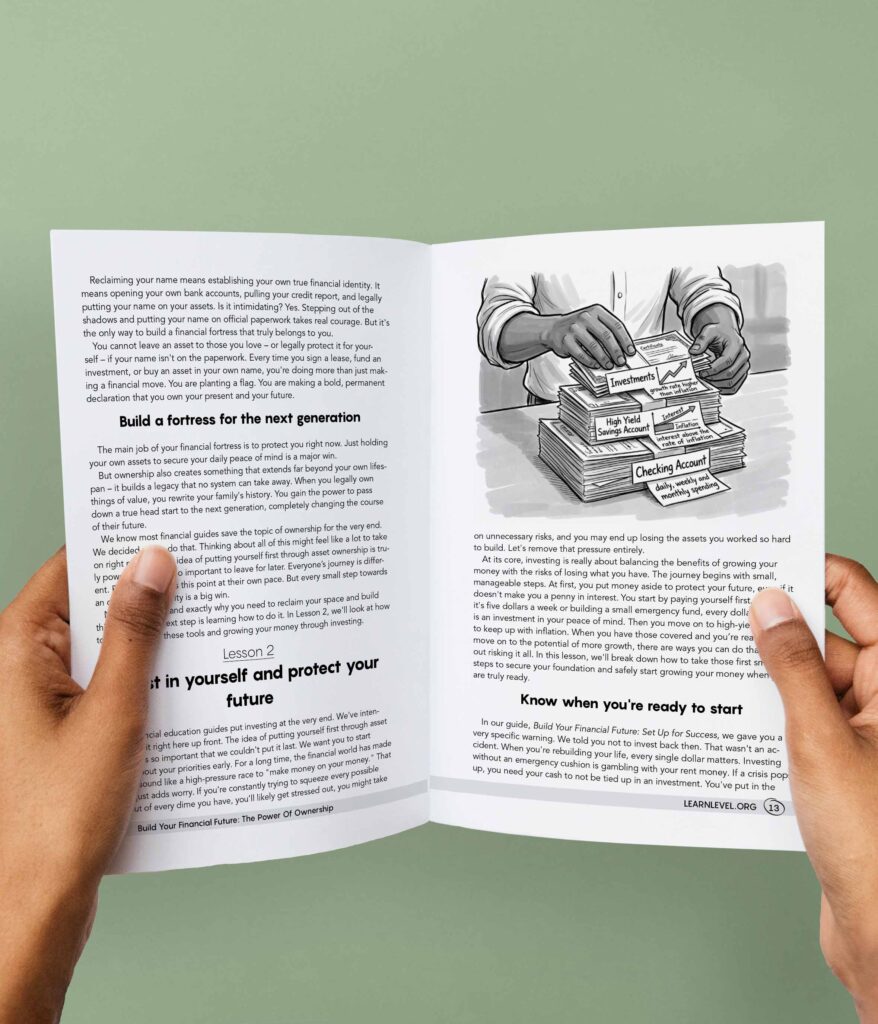 Hands holding an opened printed version of Level's prison education guide Build Your Financial Future: The Power Of Ownership